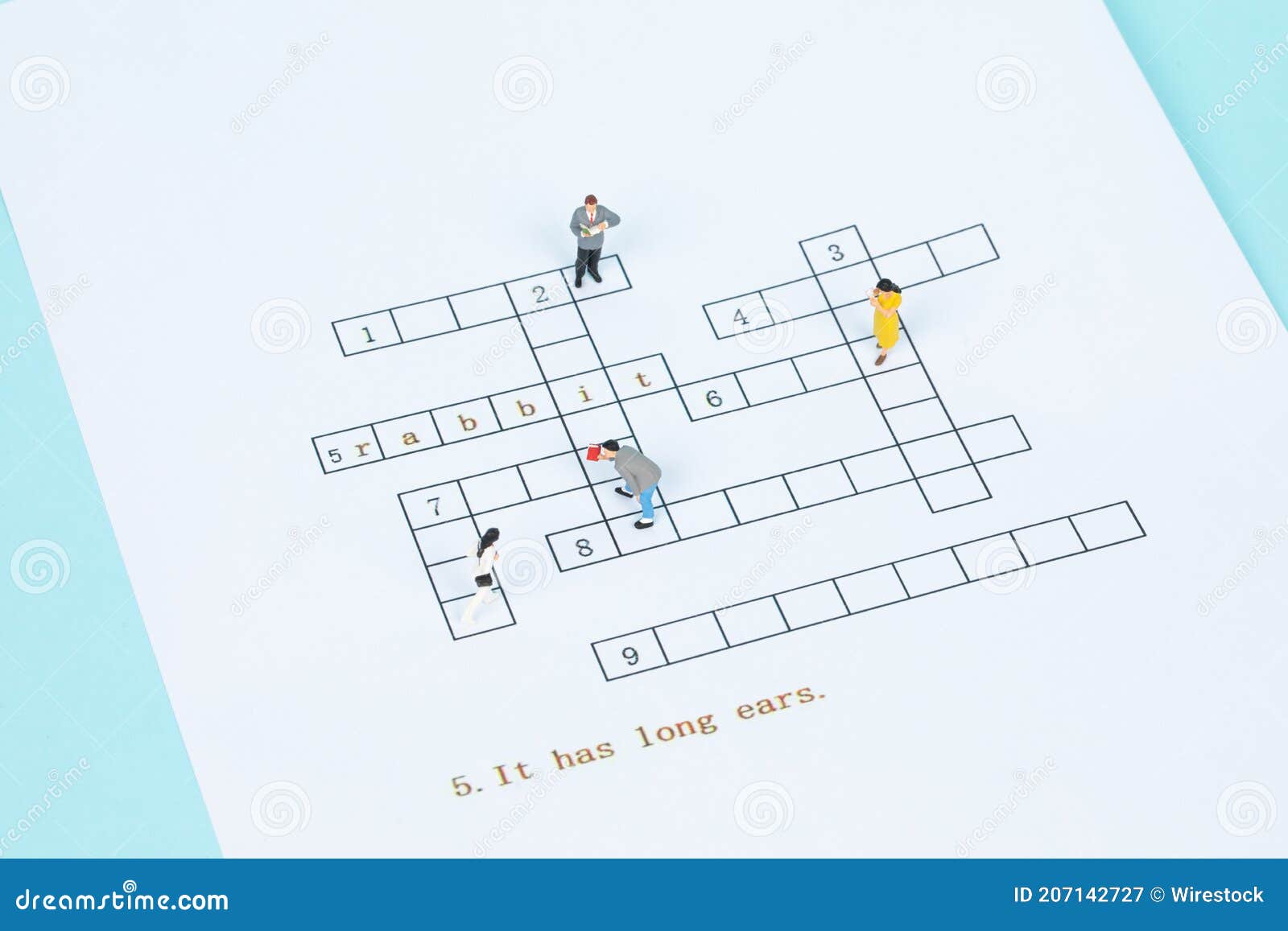 Closeup of Different Figurines Standing on a Crossword Puzzle Stock Image Image of male