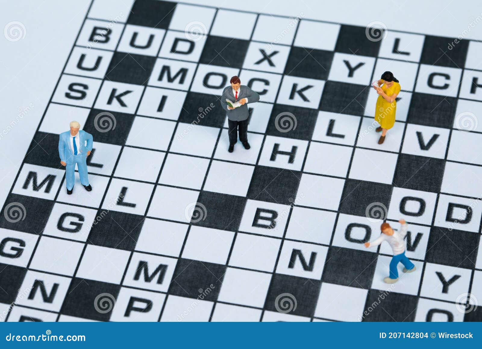 Closeup of Different Figurines Standing on a Crossword Puzzle Stock Photo Image of creative