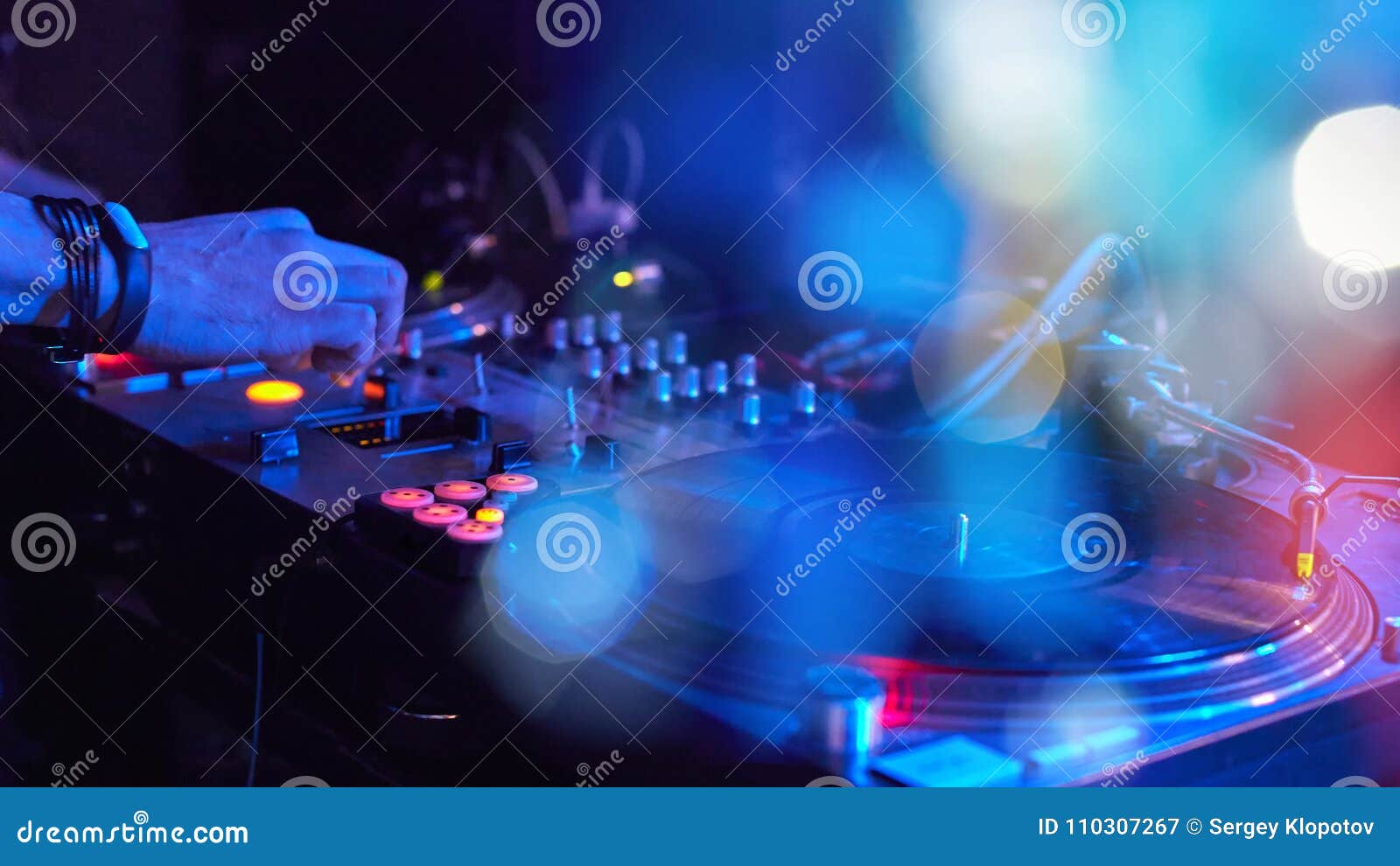 closeup dj playing at disco progressive electric music on a beau