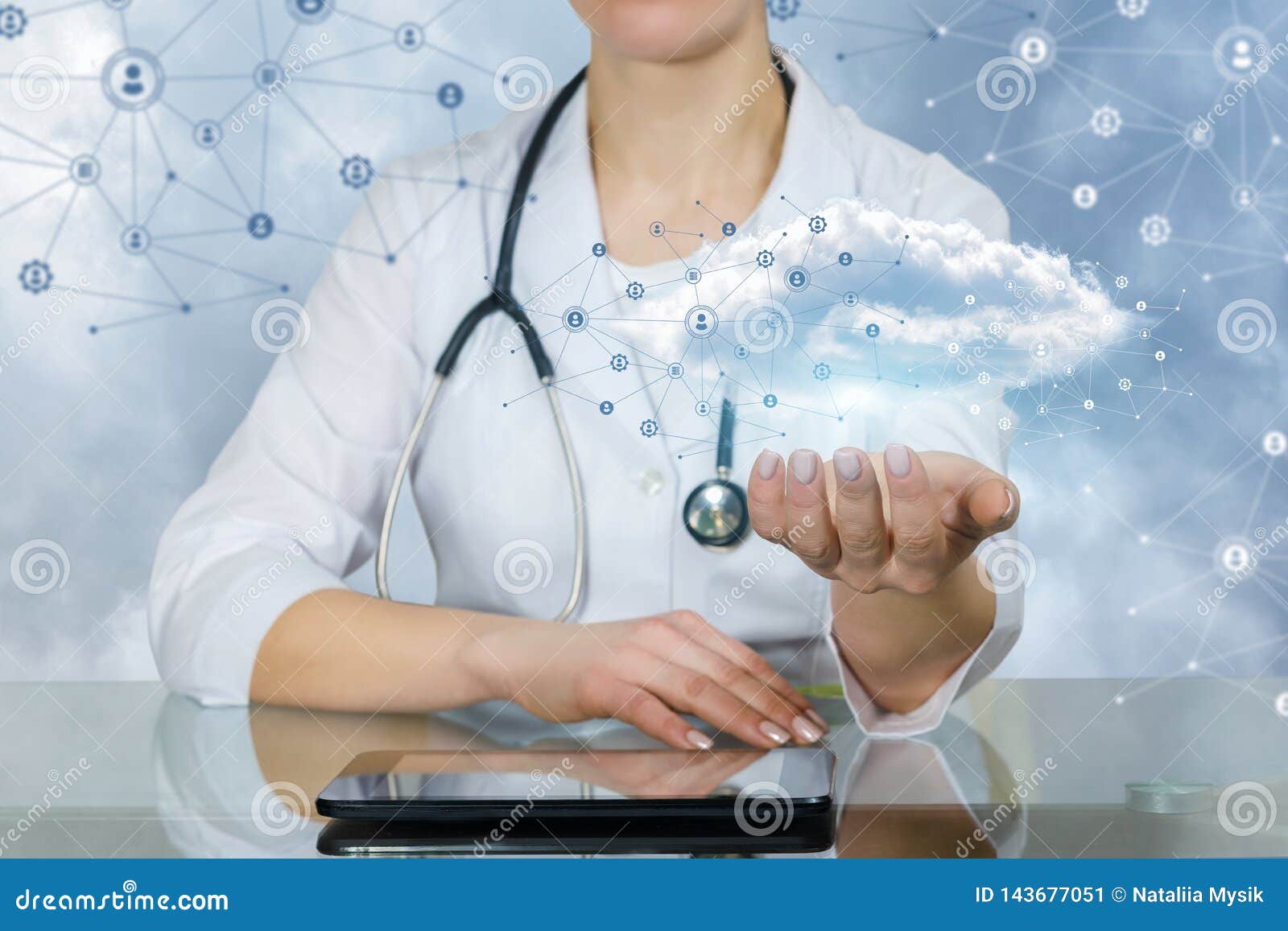 A Doctor Holding an Information and Data Cloud Above a Tablet Stock
