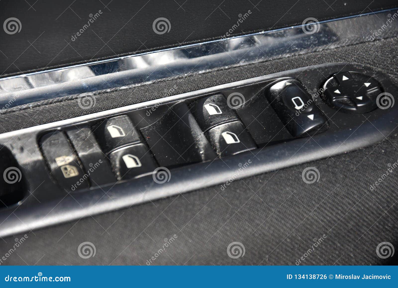 Closeup of a Door Control Panel in a Modern Car. Arm Rest with Window
