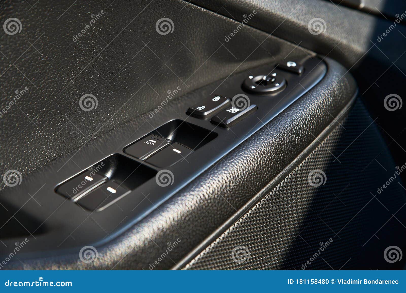 Closeup of a Door Control Panel in a New Car. Arm Rest with Window Control Panel, Door Lock