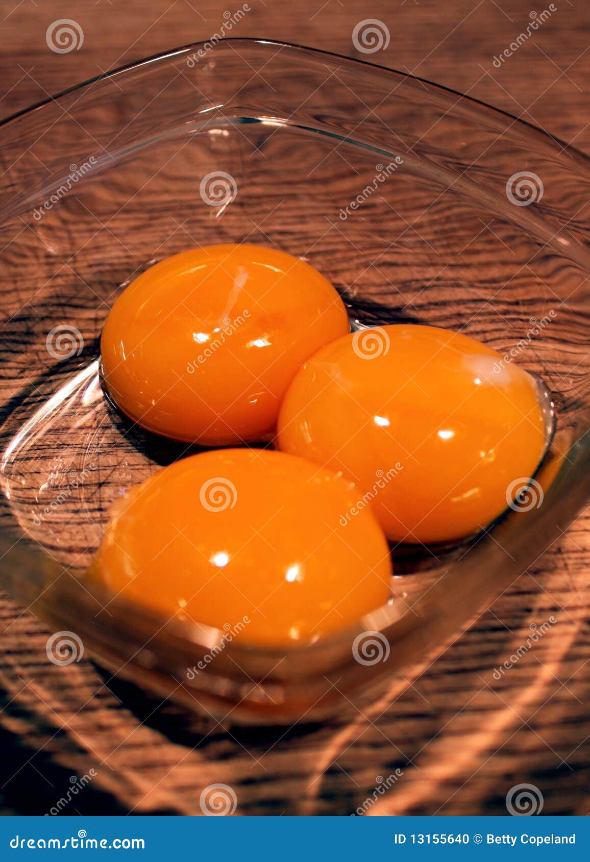 Closeup egg yolks stock photo. Image of three, yolk, yellow 13155640