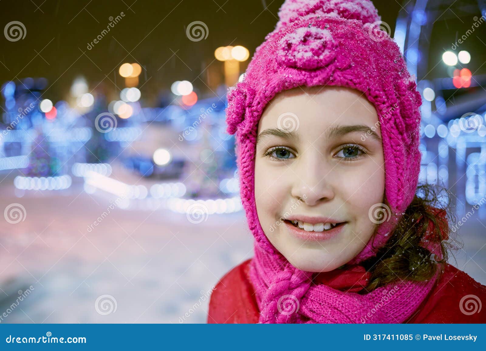 closeup face of little girl in winter knitted hat