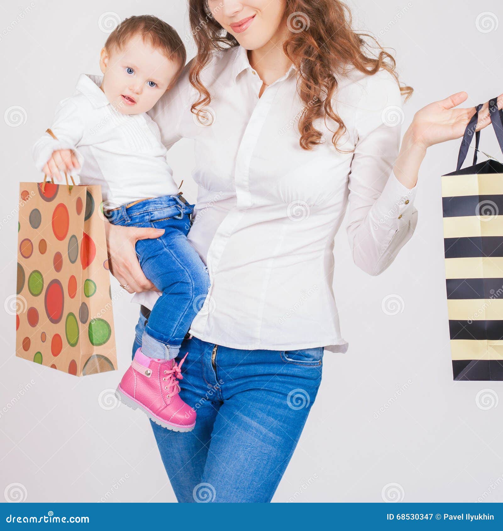 Closeup Fashion Mother And Funny Baby Holding Bags With Purchases Stock ...