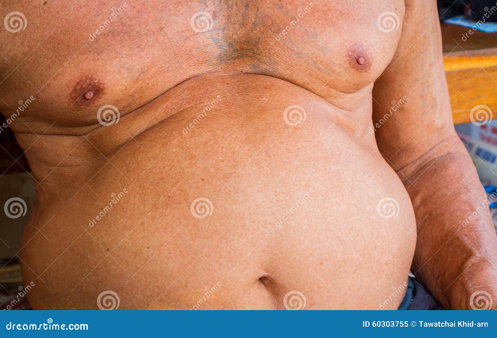 closeup fat asian man has a big paunch
