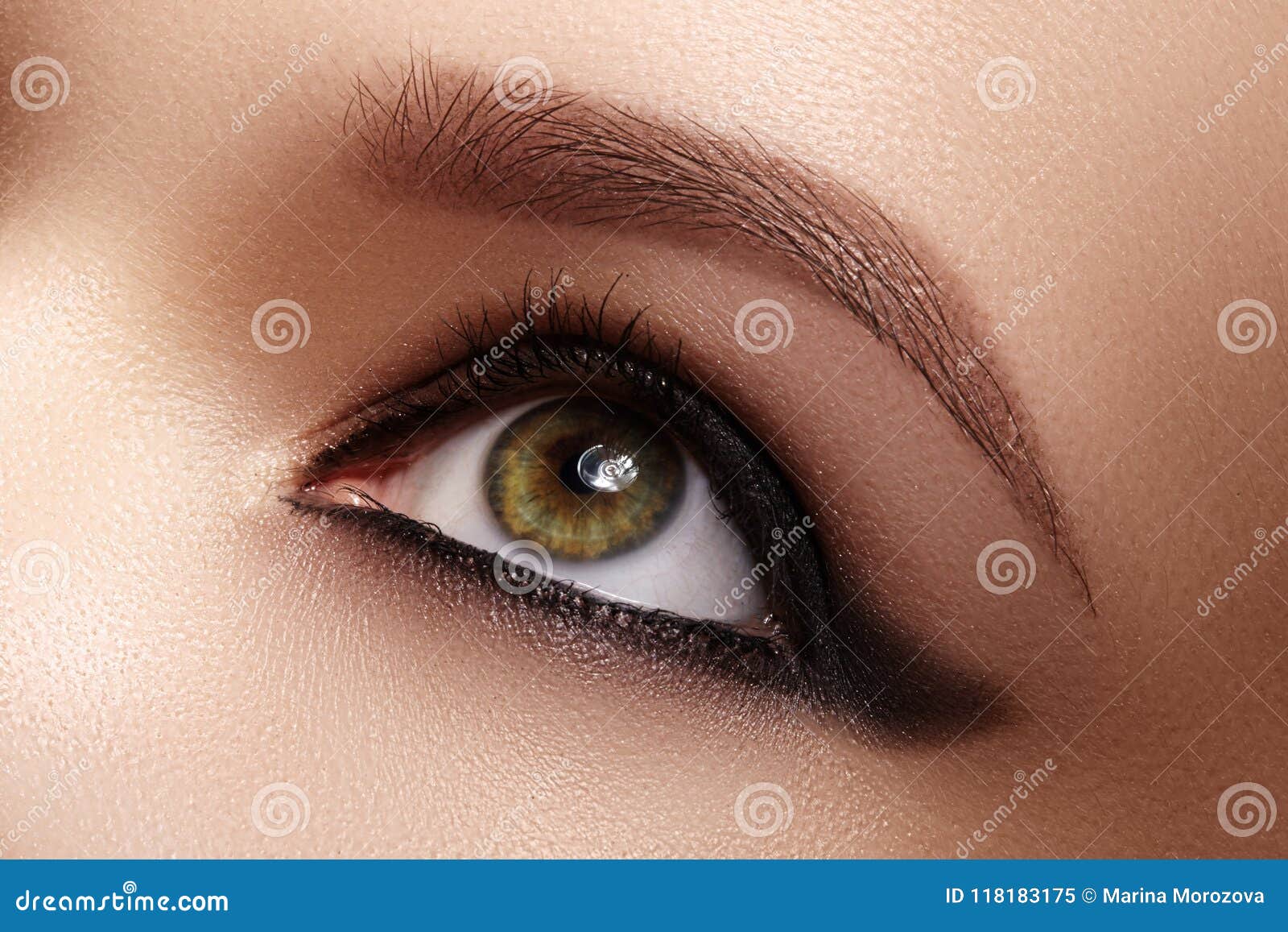 closeup female eye with dark make-up, great s brows. celebrate makeup, luxury eyeshadows. fashion eyeliner, pencil