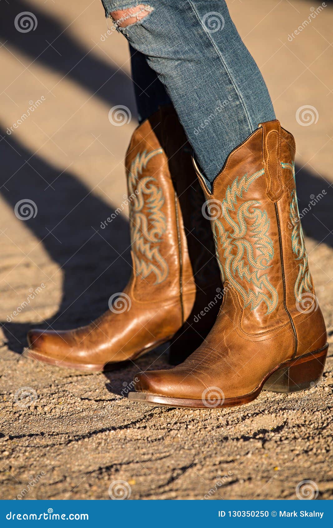 ripped jeans with cowboy boots