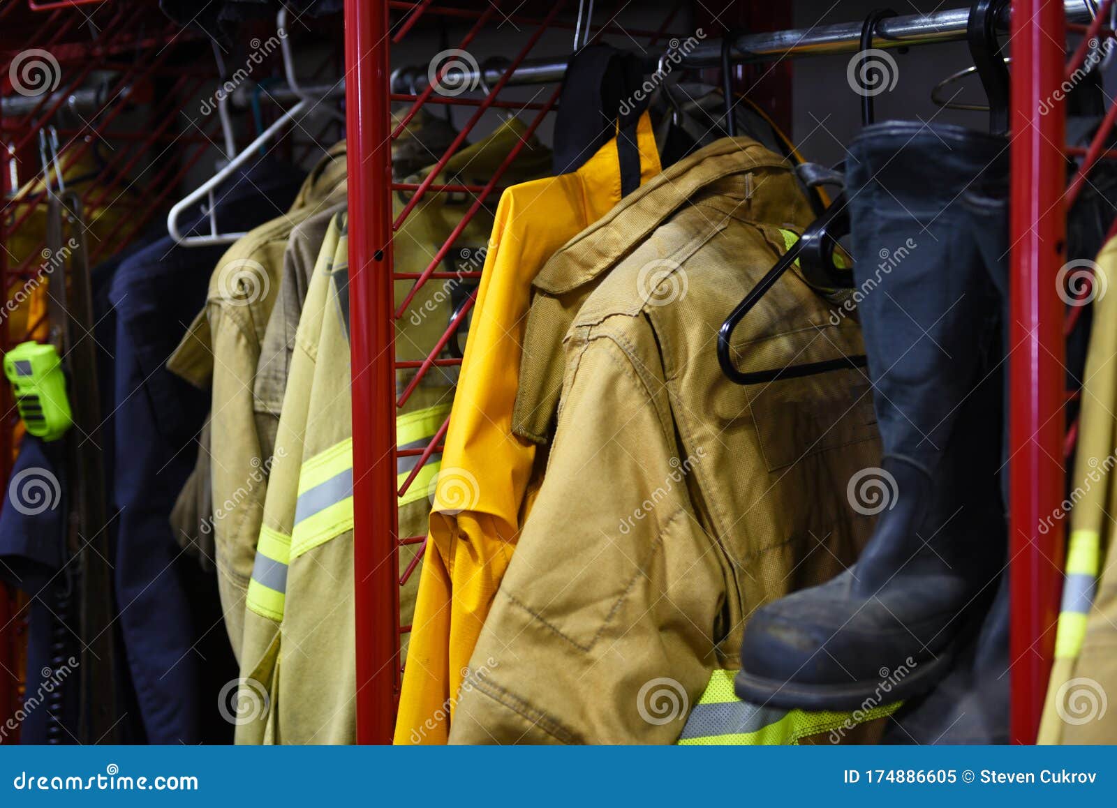 Closeup of Firefighter Gear on Hangers Inside a Fire Station Stock