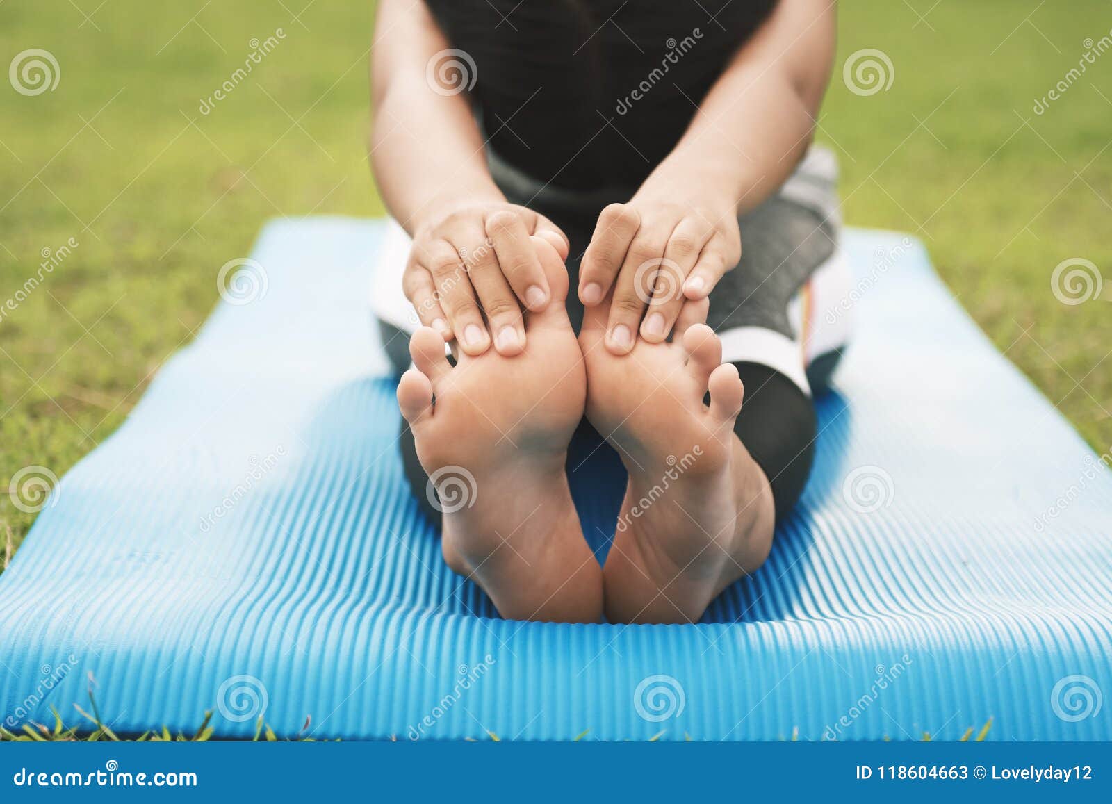 closeup foots of a young woman practicing yoga