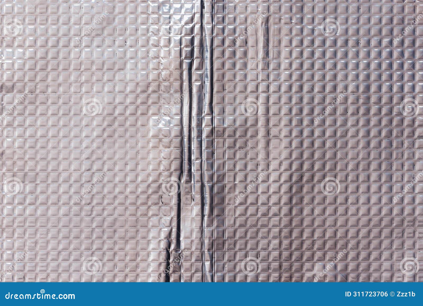 closeup full-frame background and texture of aluminum coated butil rubber sheet with square pattern.