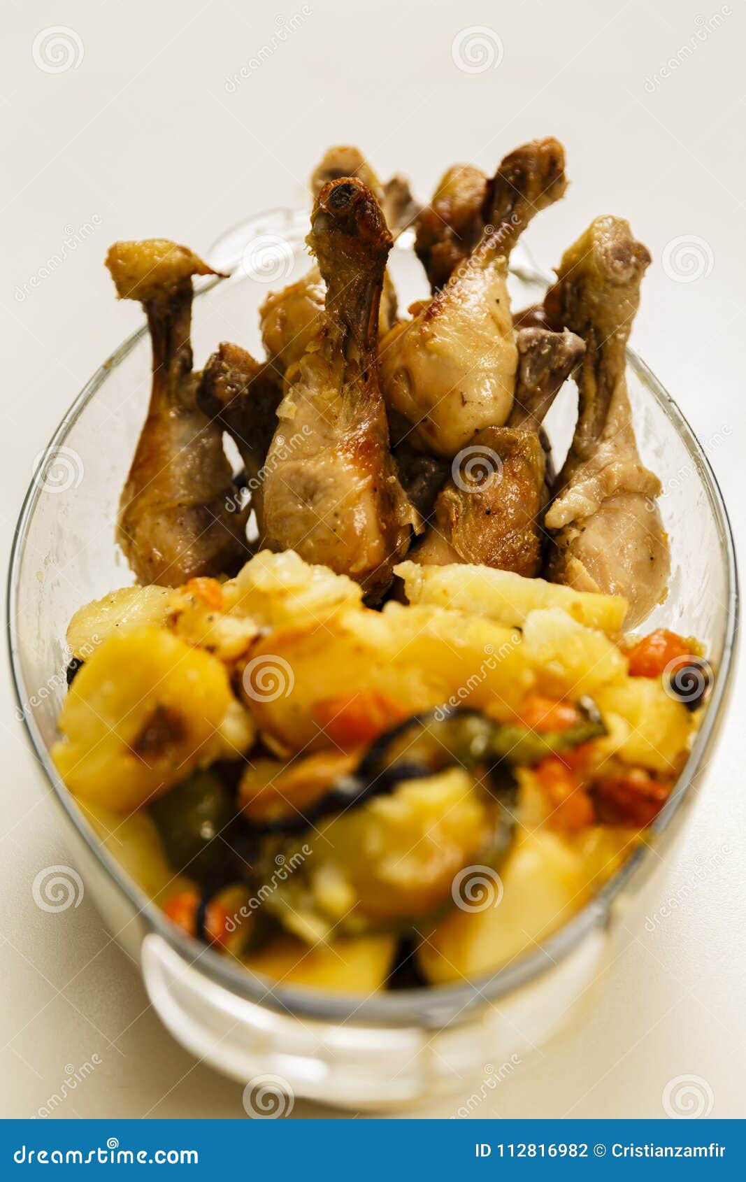 Closeup of Grilled Chicken Drumsticks with Potato Chips Stock Photo
