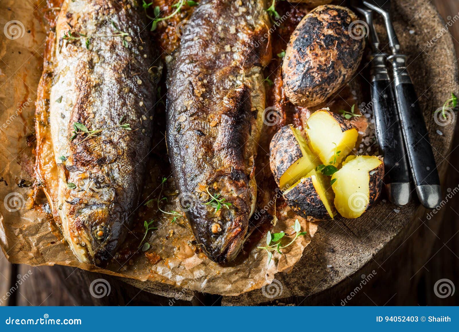 Closeup of Grilled Trout Fish and Potatoes with Butter Stock Image