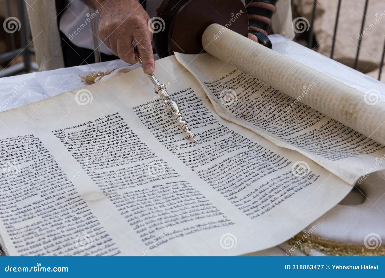 a reader of the torah uses a yad or pointer as a guide