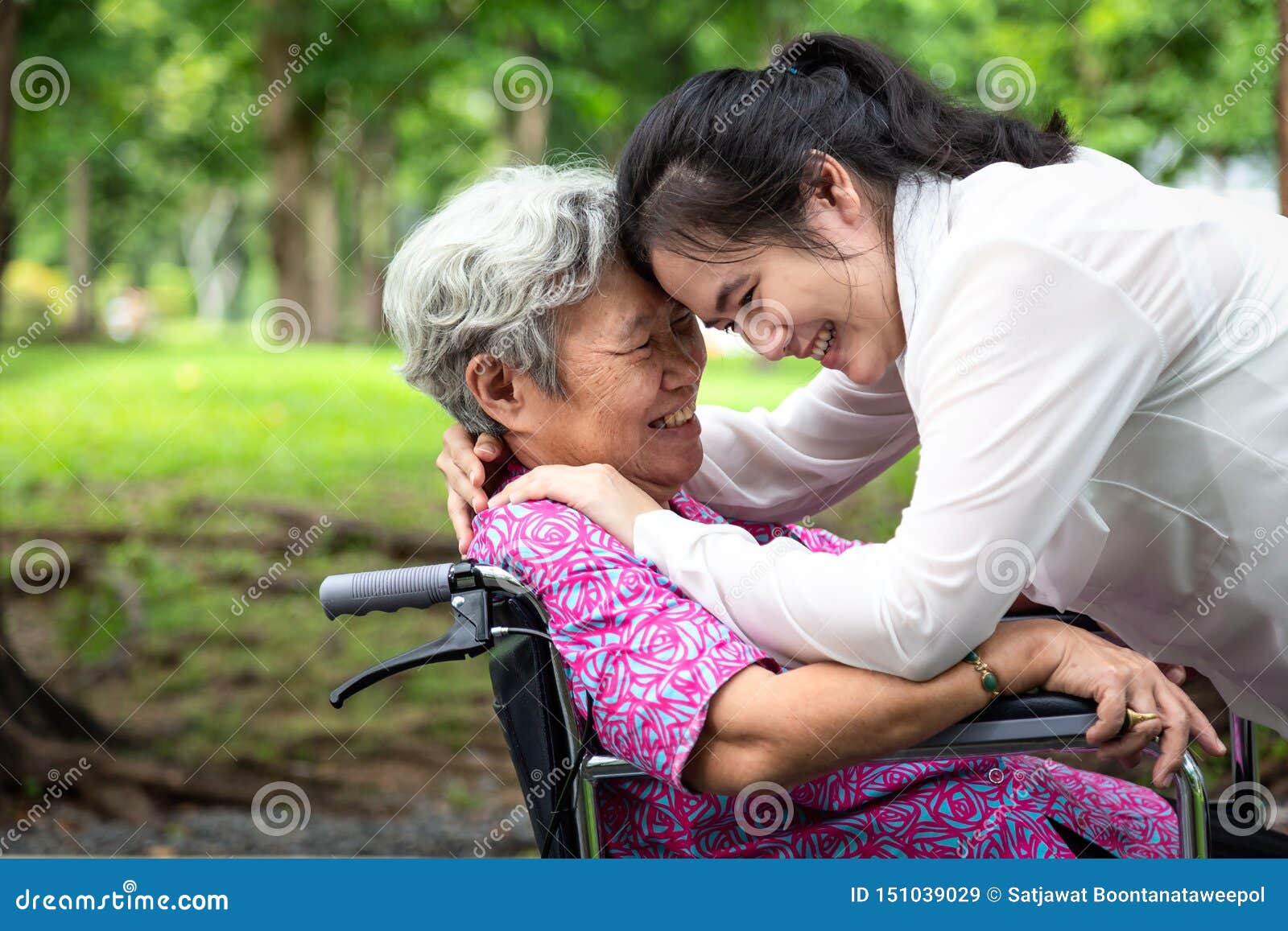 closeup,happy beautiful asian senior people with adult woman hugging,smiling in summer,love of mother with her daughter in
