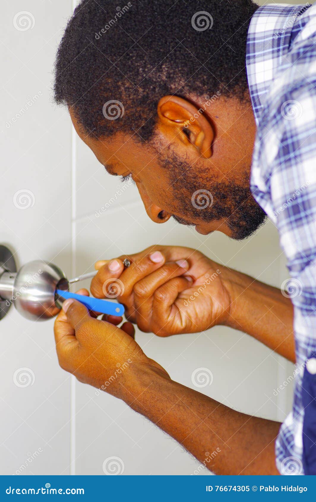 Closeup Head and Hands of Locksmith Using Pick Tools To Open Locked Door Stock Image Image of