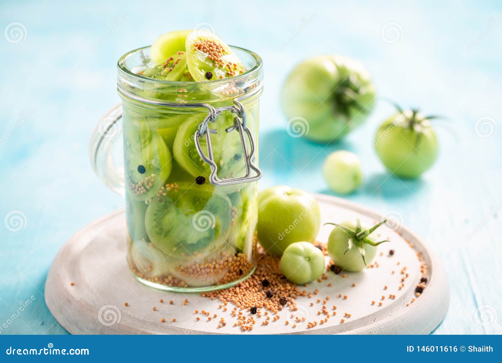 Closeup of Healthy Pickled Green Tomatoes in the Jar Stock Photo