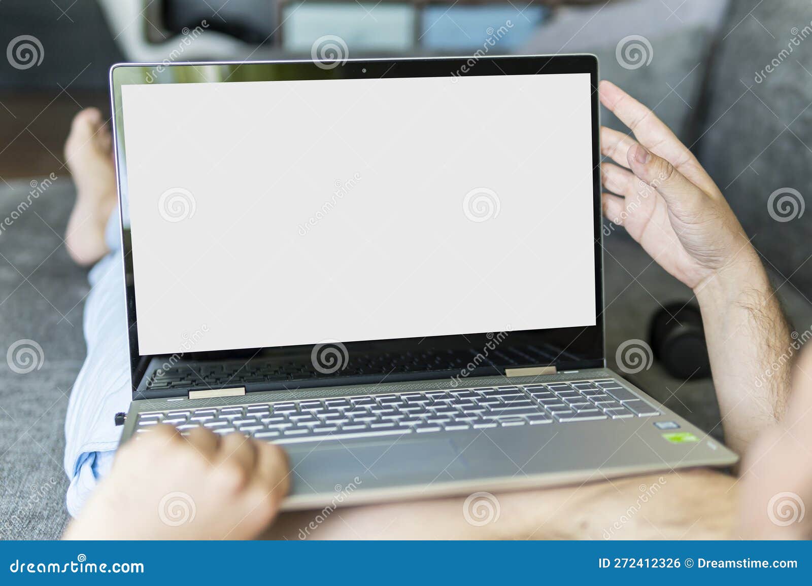 Closeup Image of Man Lying on Bed Working on Laptop Computer. POV Shot