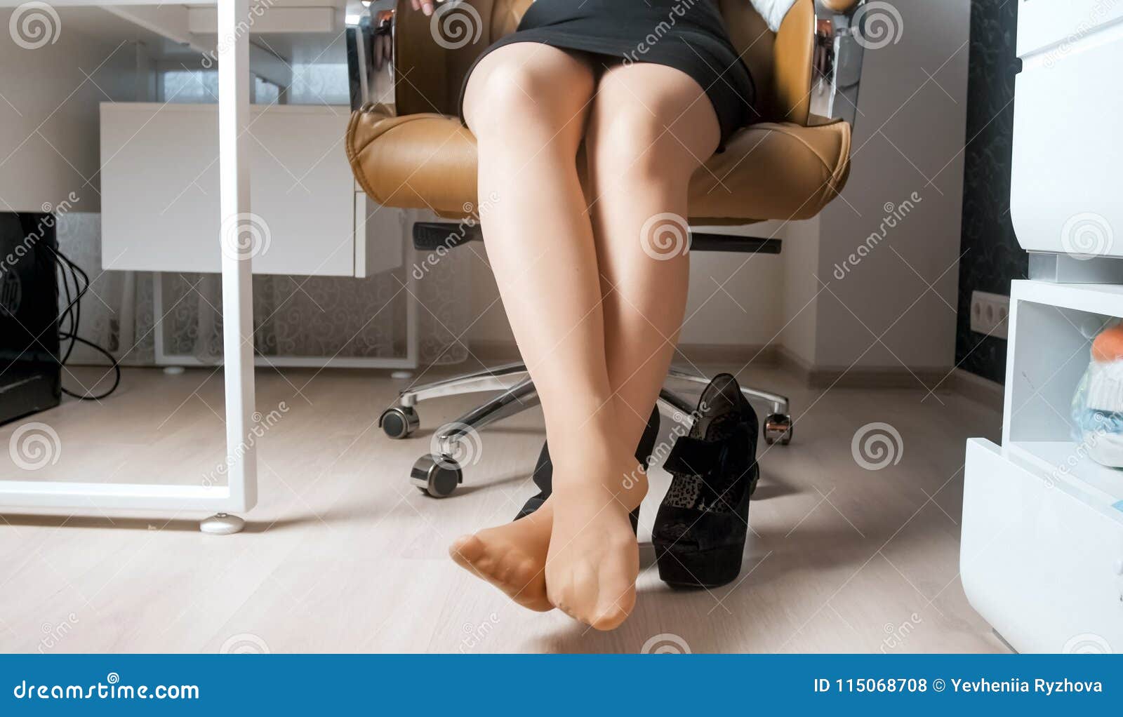 Closeup Image Of Businesswoman Resting Feet Under Desk Stock Photo, Picture  and Royalty Free Image. Image 100729228.