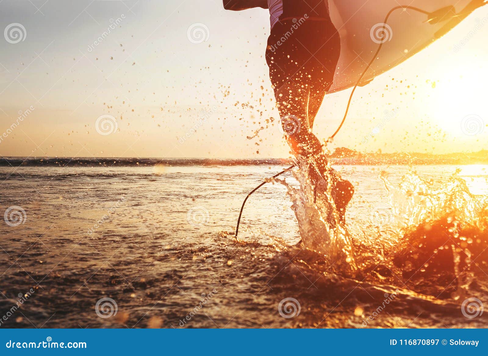 closeup image water splashes from surfer`s legs run in ocean wit