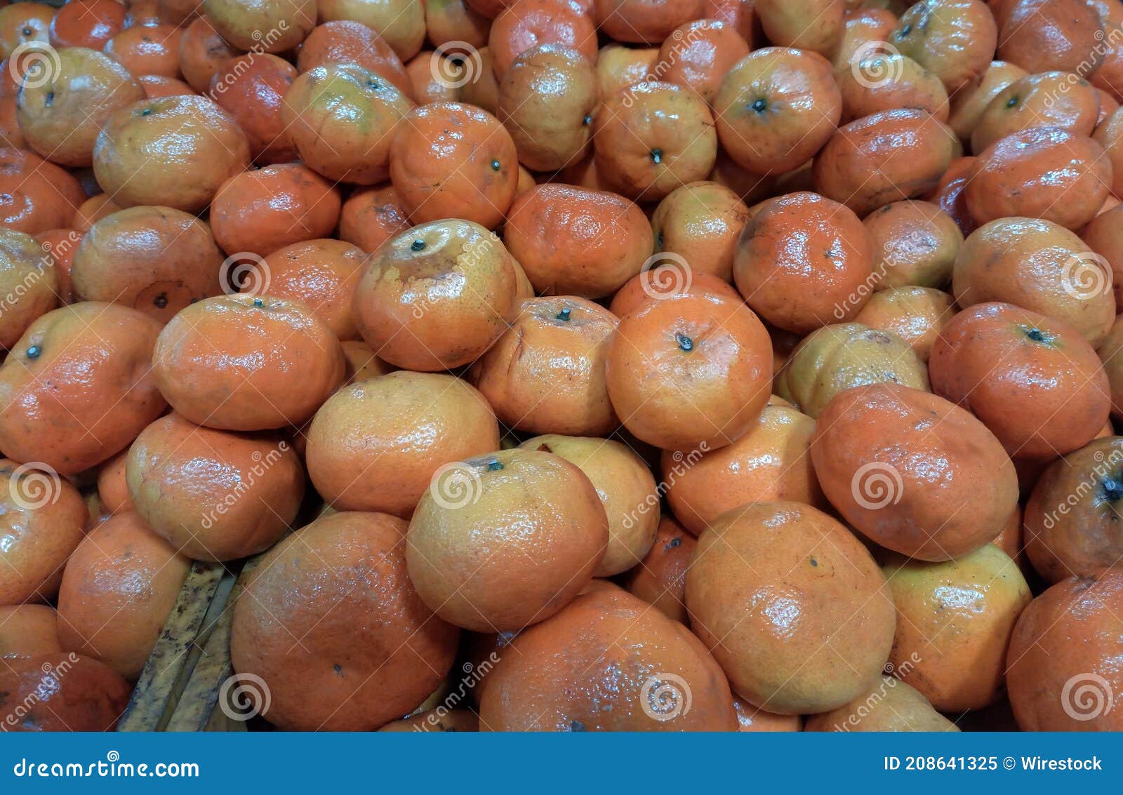 closeup of juicy ripe orange tangerines (citrus reticula) at the market good as a background