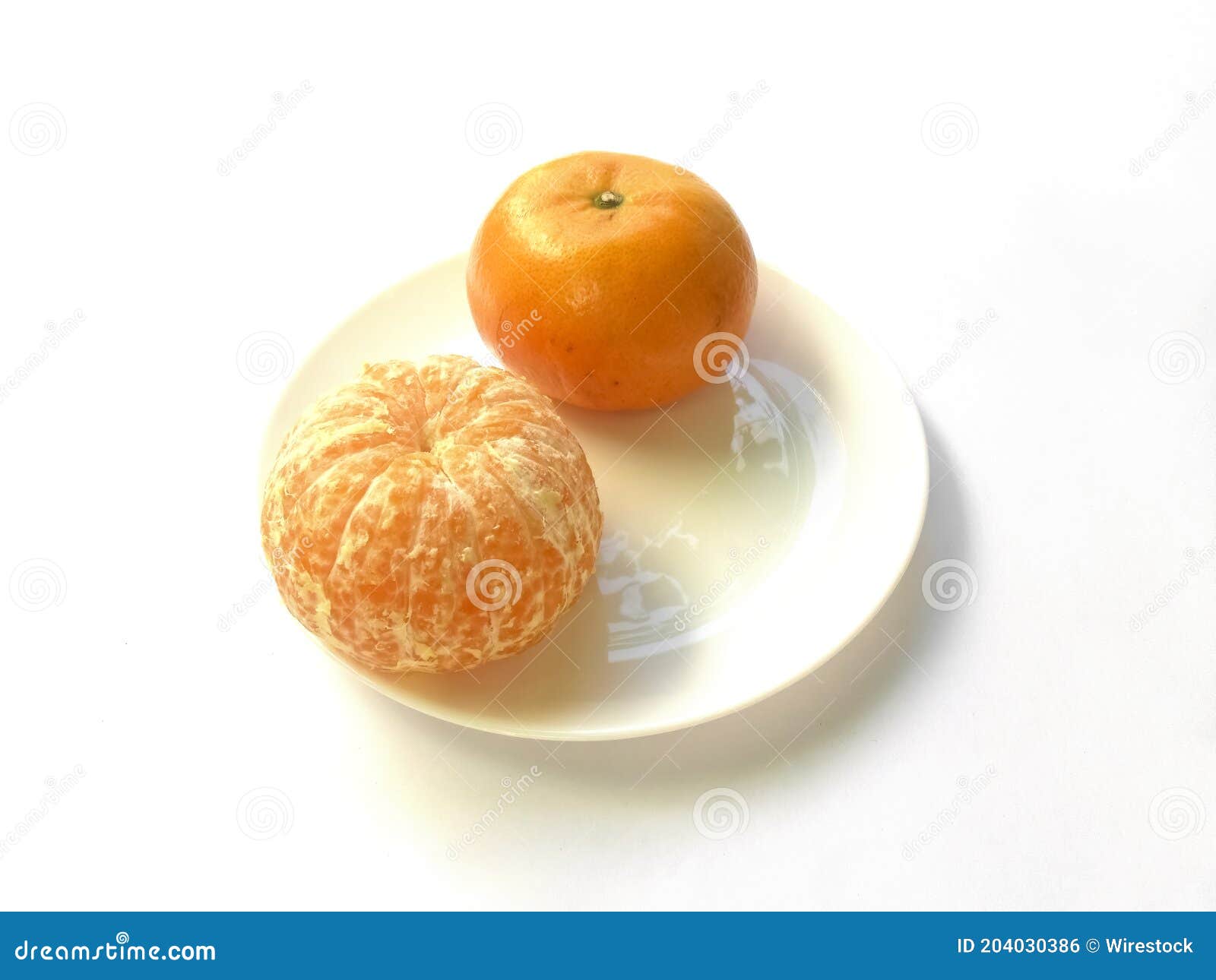 closeup of juicy ripe orange tangerines (citrus reticula) peeled on a plate with a white background
