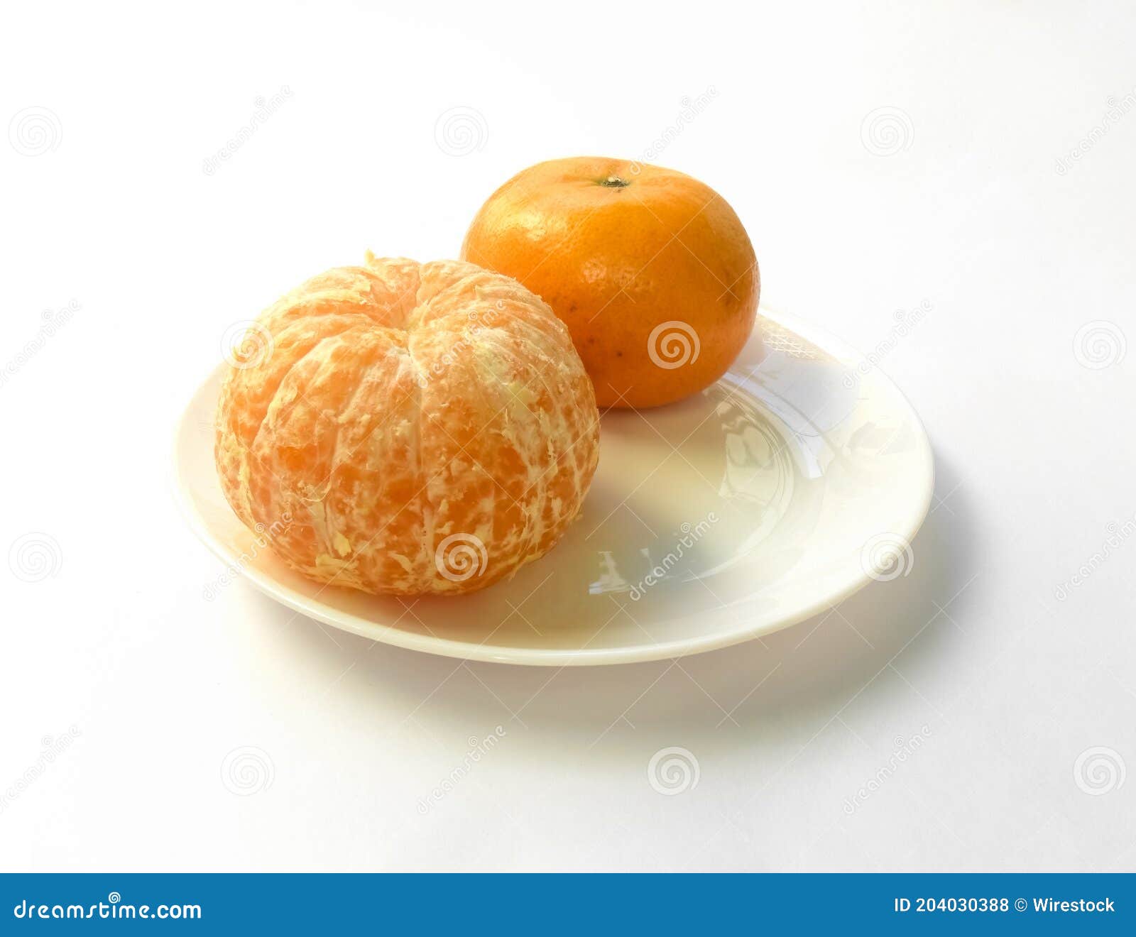 closeup of juicy ripe orange tangerines (citrus reticula) peeled on a plate with a white background