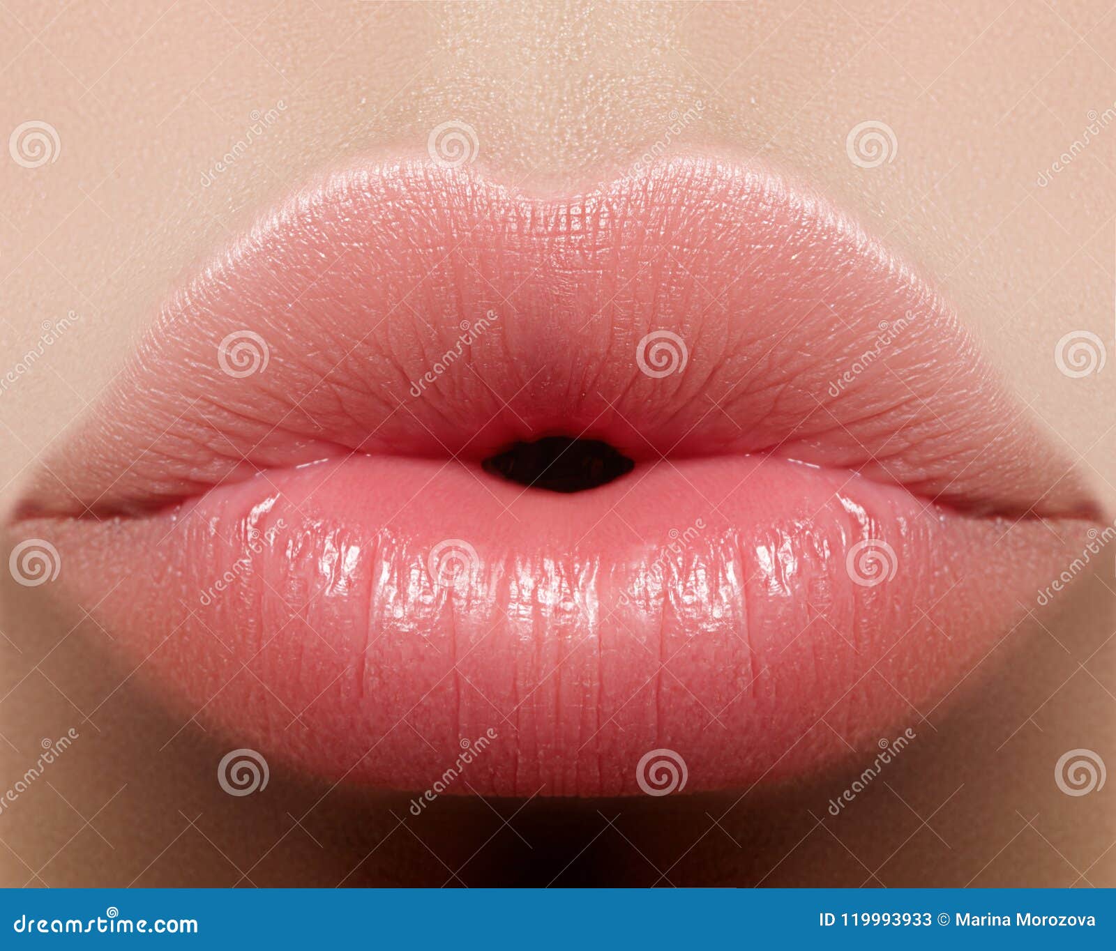 closeup kiss natural lip makeup. beautiful plump full lips on female face. clean skin, fresh make-up. spa tender lips