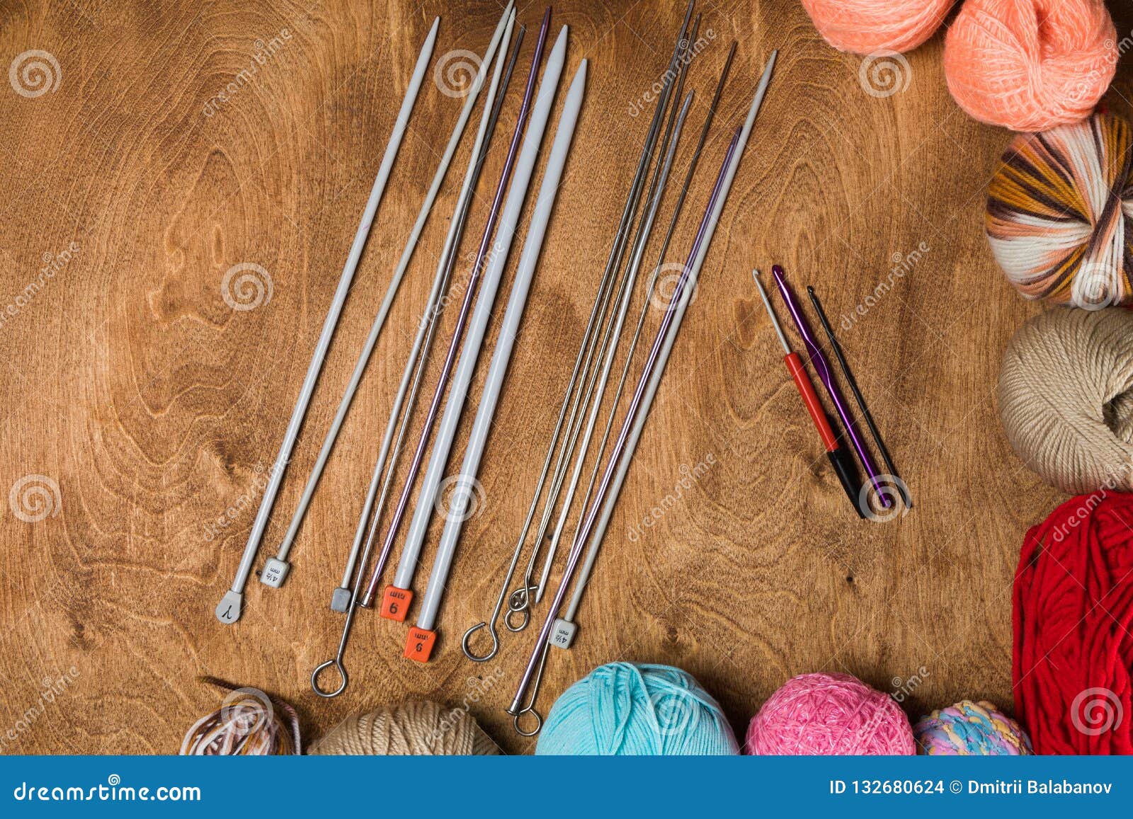 Closeup of Knitting Needles with Balls of Yarn in Different Colors