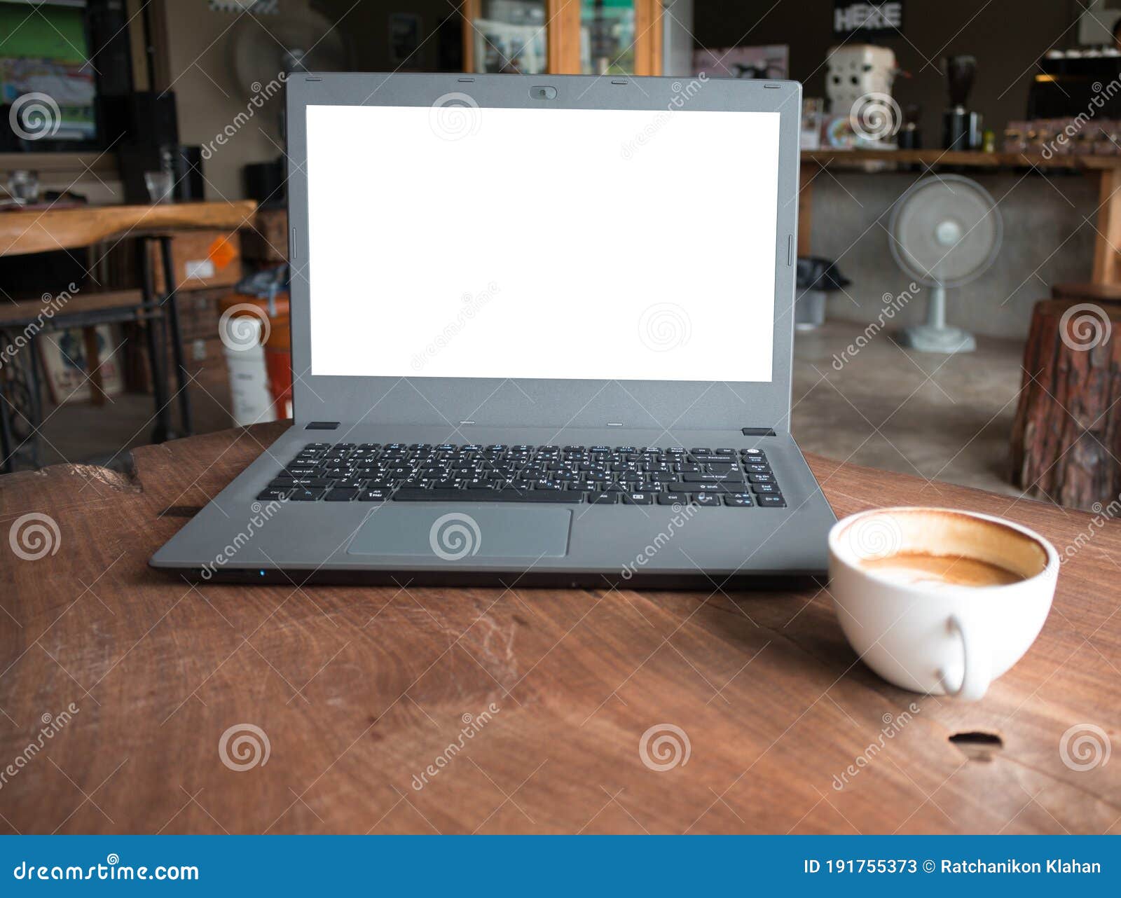 closeup of laptop computer with blank display in coffee shop concept image made advertised product.