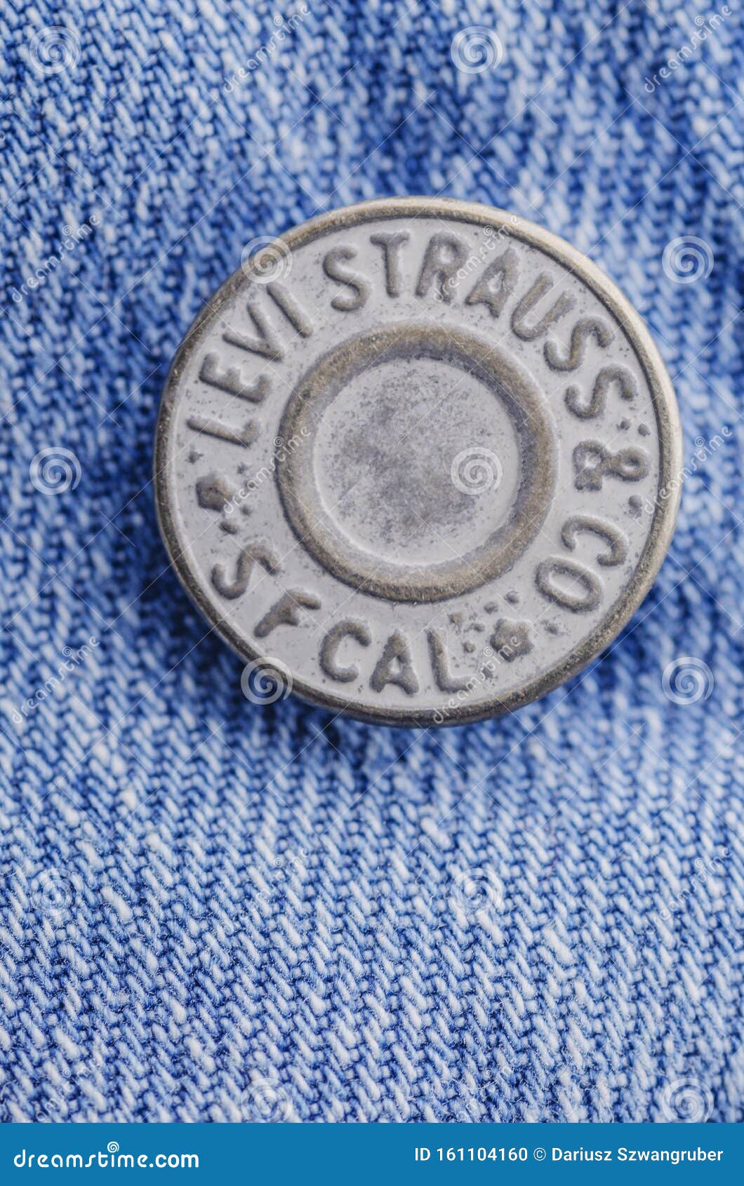 Closeup Of Levi Strauss Button On Blue 