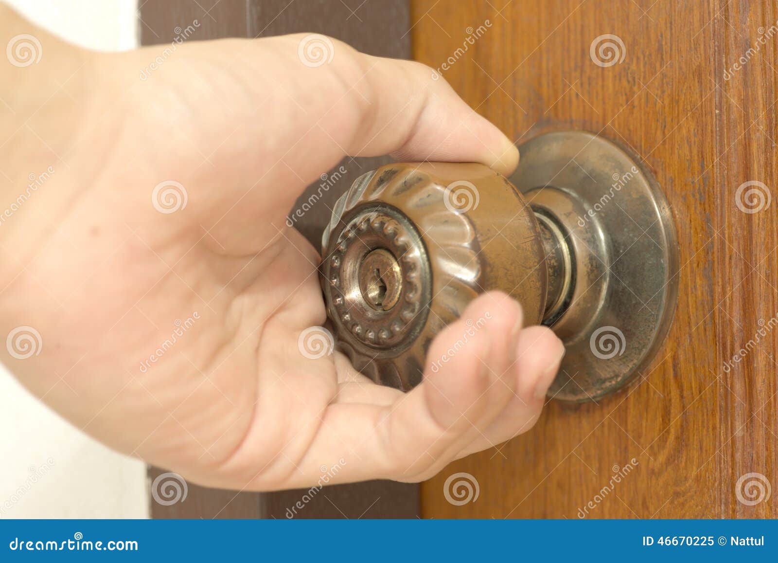 closeup of male hand opening door knob