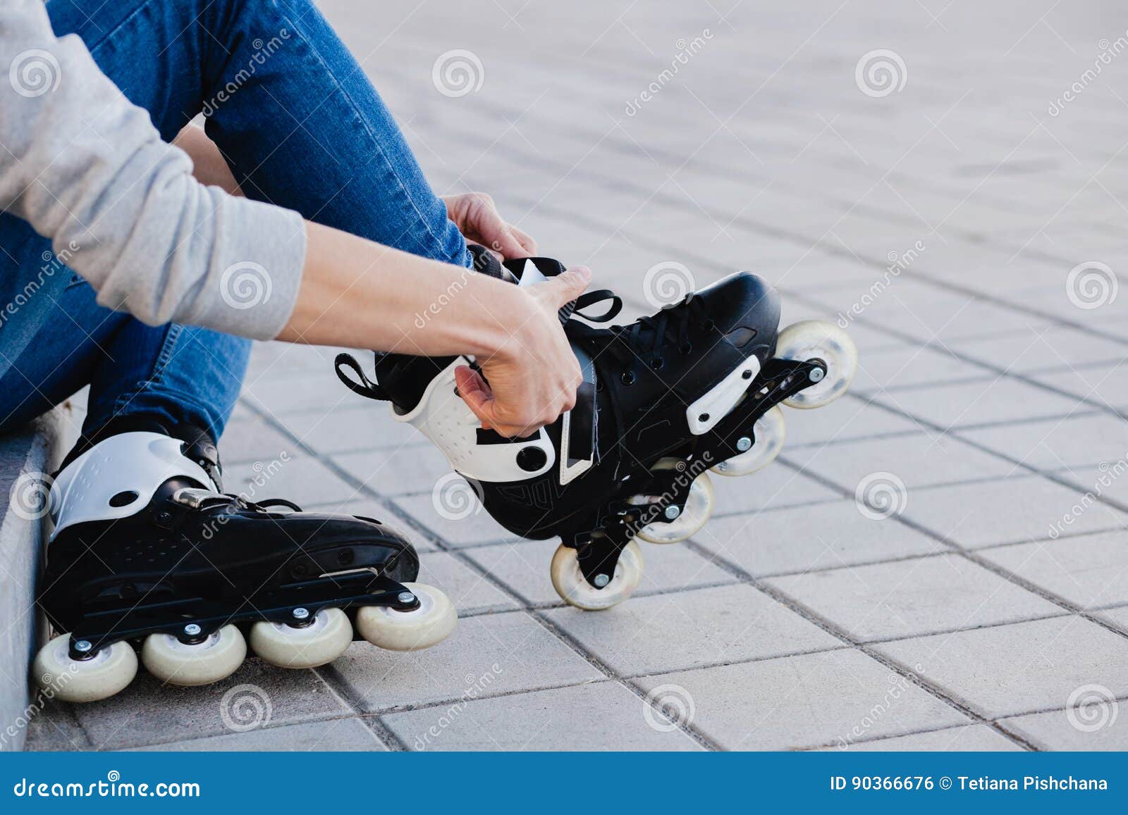 Closeup of Man Guy Putting on Roller Skates Outdoor. Stock Photo