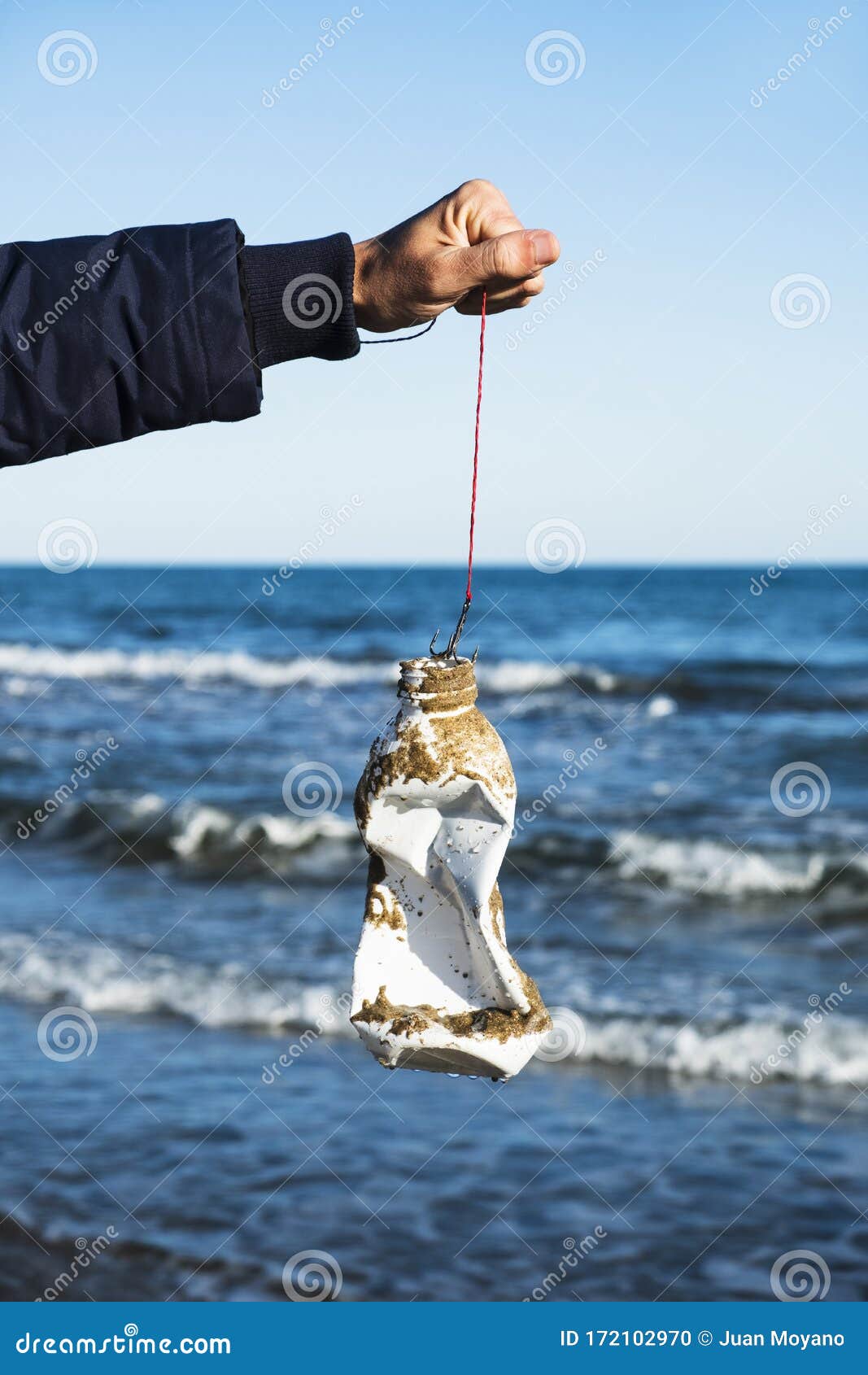 Man Fishing a Used Plastic Bottle in the Sea Stock Photo - Image of dump,  object: 172102970