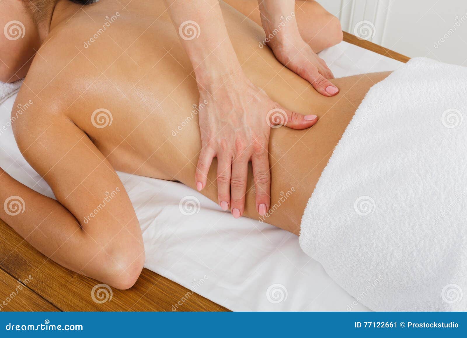 closeup massagist hands make body massage in spa wellness center