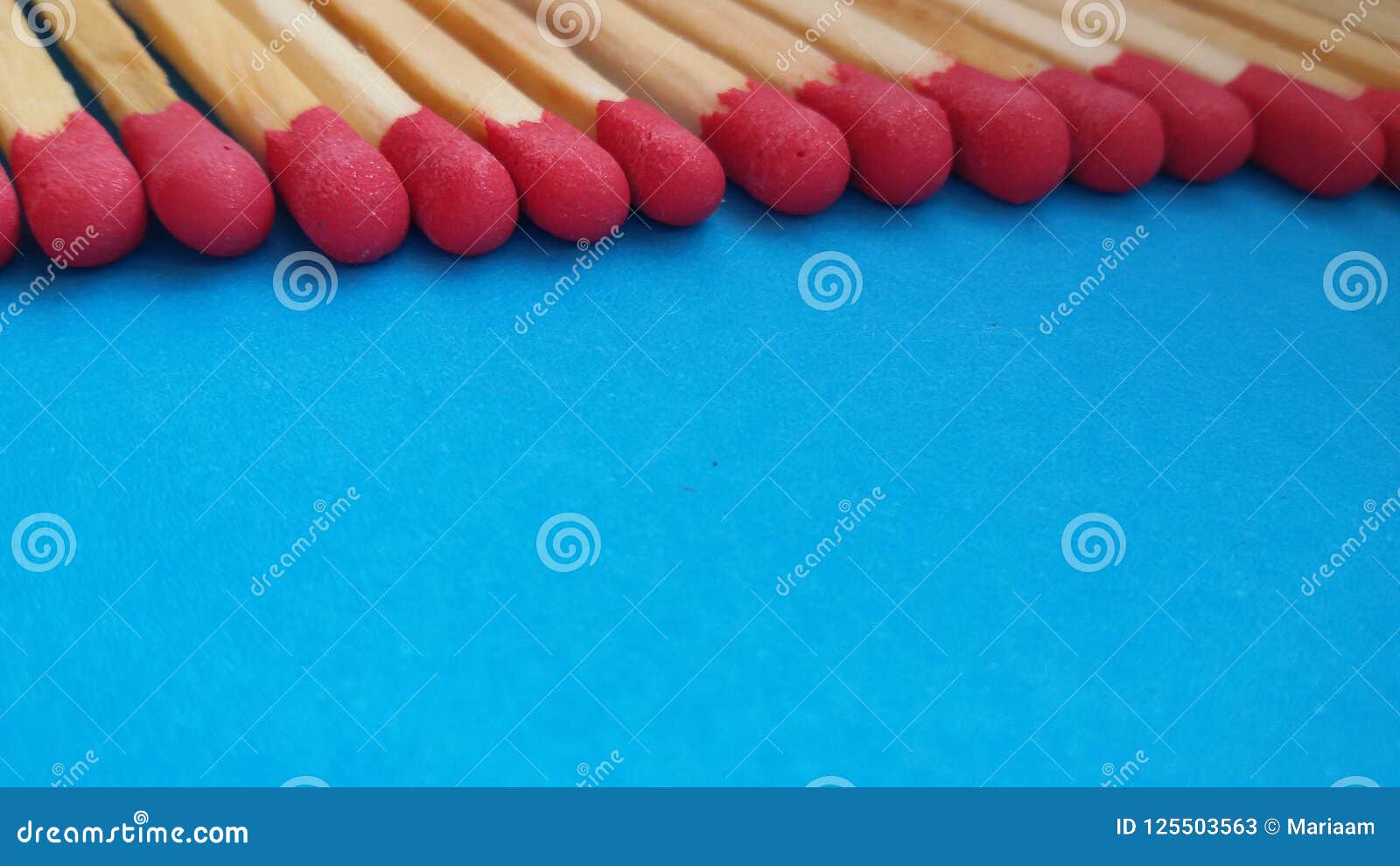 matchsticks in a row over blue background.