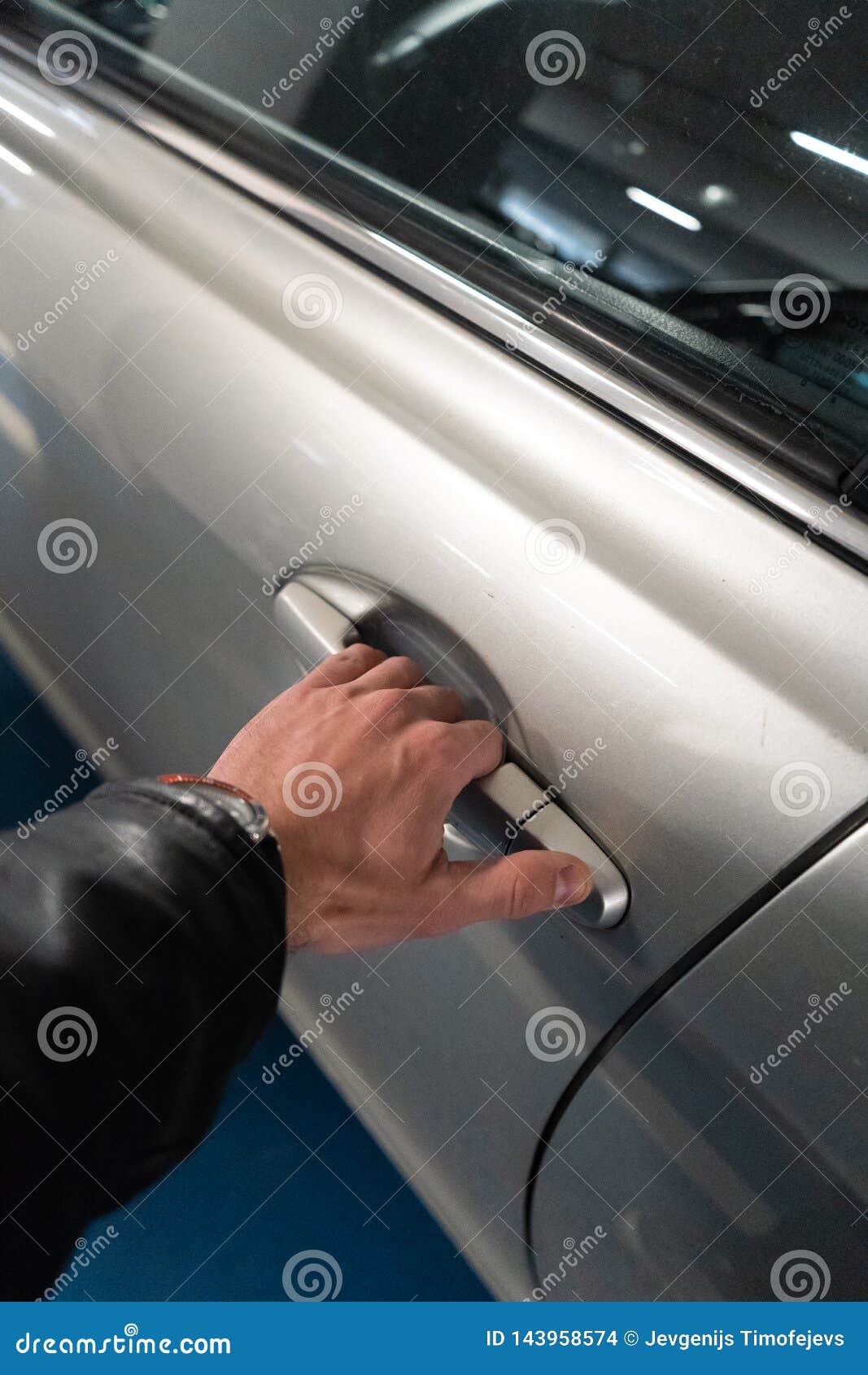 Closeup A Men S Hand On The Latch Of A Car Door Opening It Up