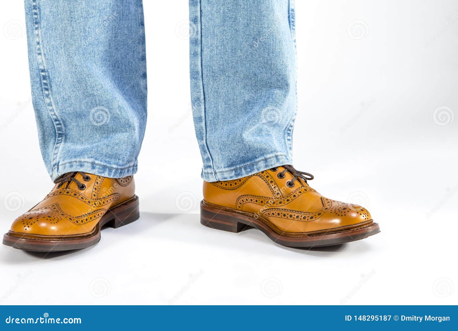 Closeup of Mens Legs on Brown Oxford Brogue Shoes. Posing in Blue Jeans ...