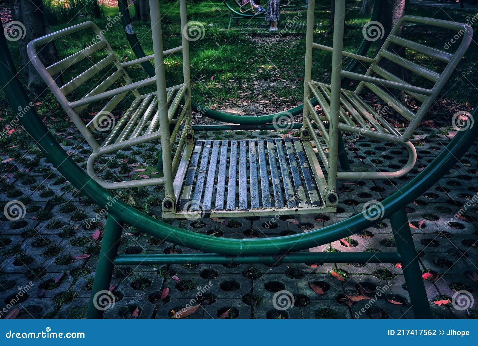 Wet Metal Swing Painted With Bright Paint On An Empty Children`s Street