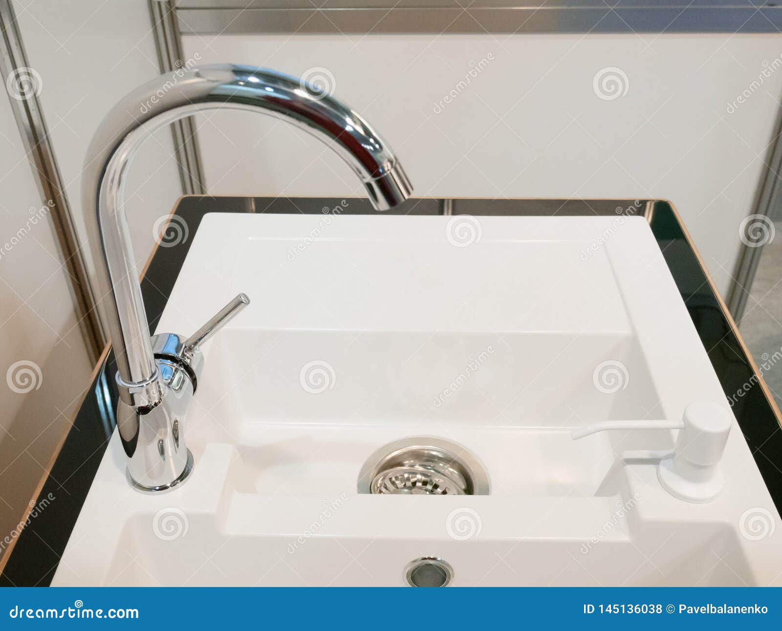 Closeup of Modern Square Kitchen Sink with Two Faucets Stock Photo