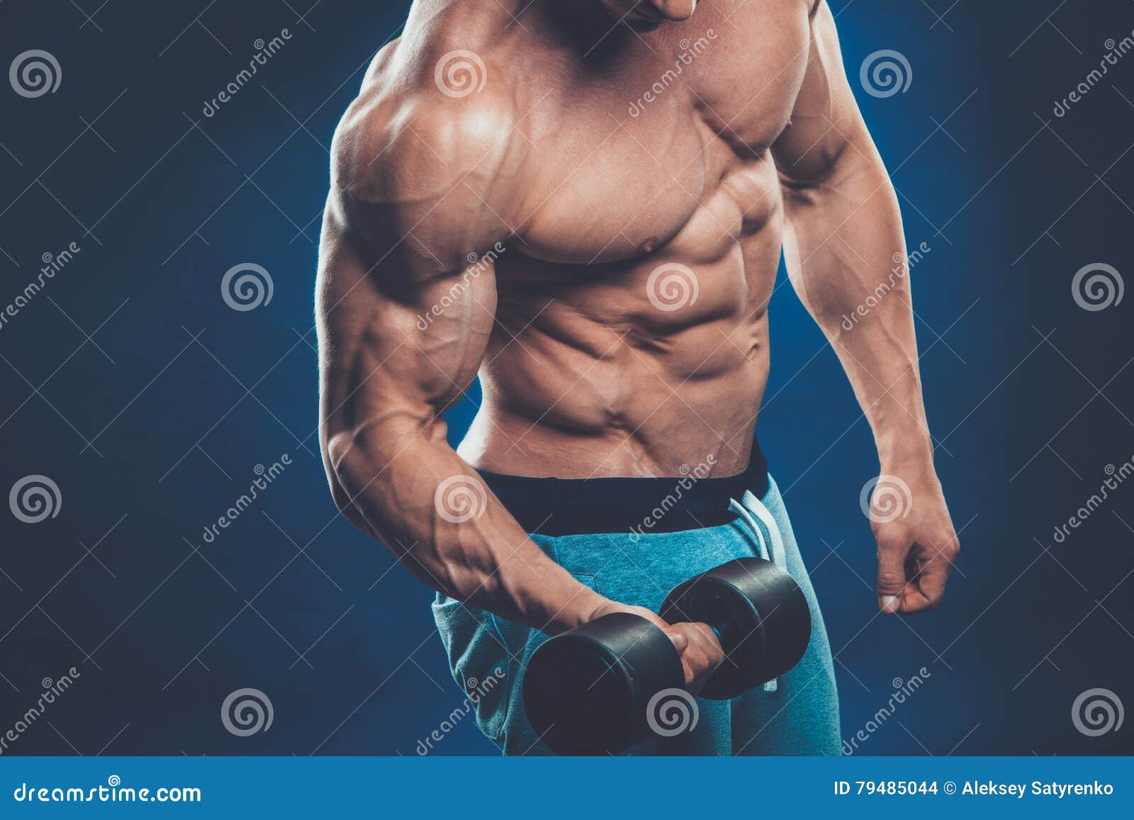 Athletic Man Showing Muscular Body And Doing Exercises 