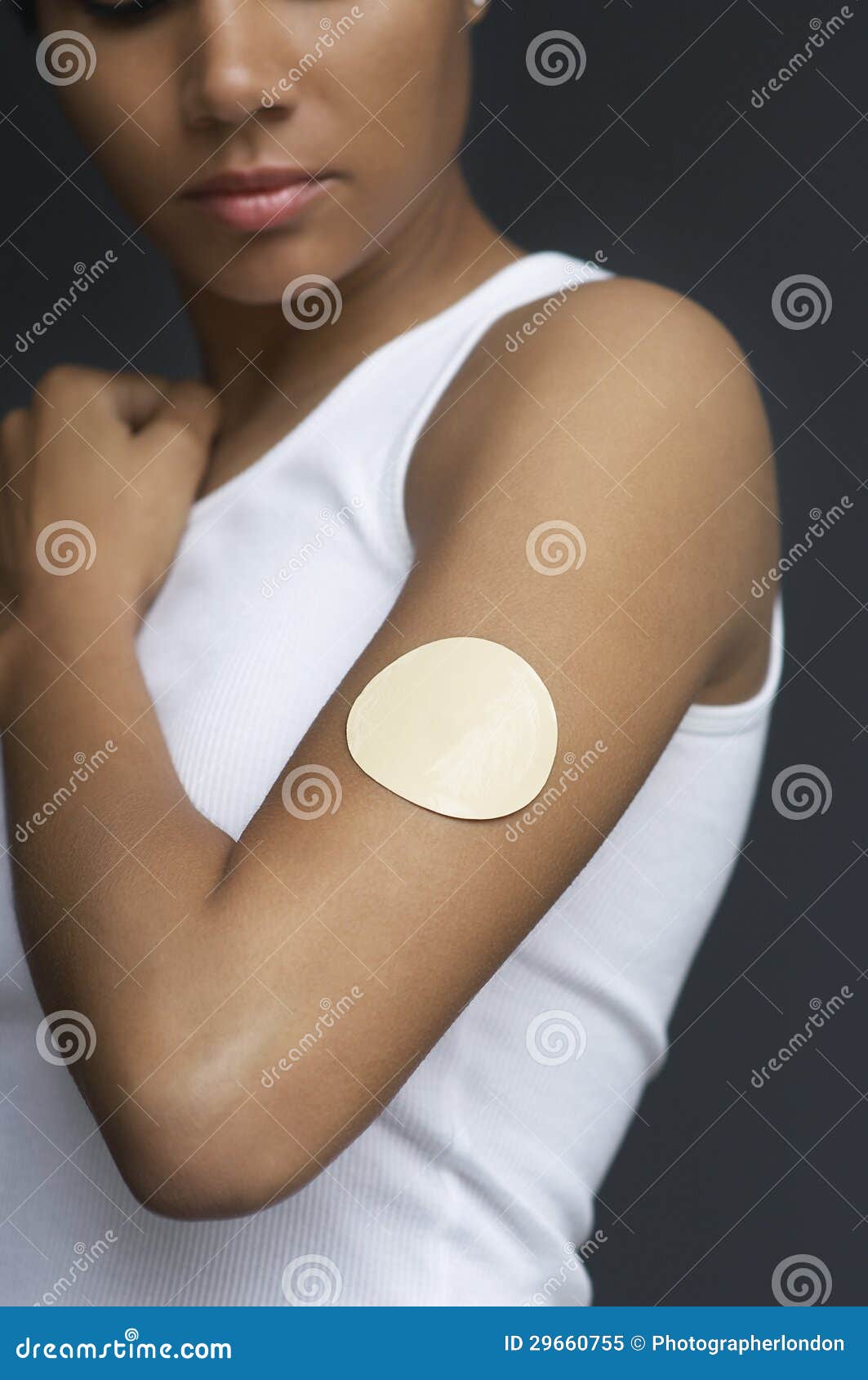 closeup of nicotine patch on female's arm