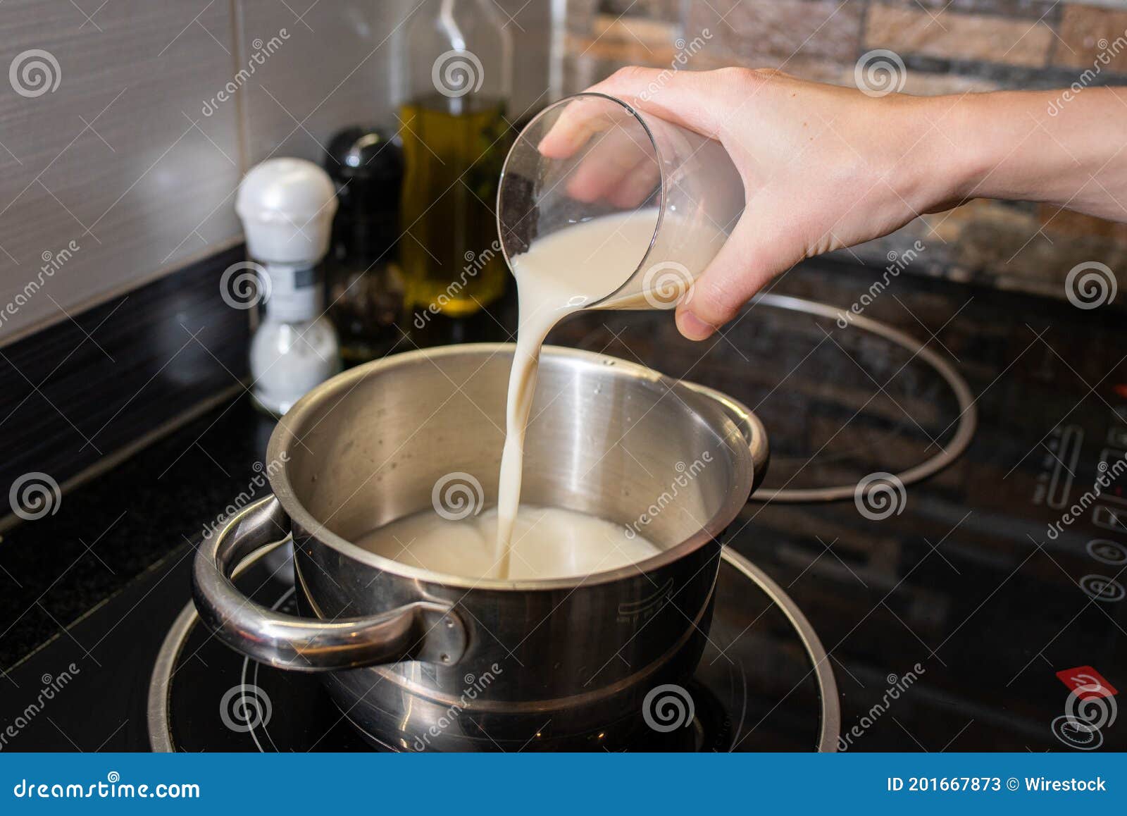 Closeup of a Person Making Oatmeal with Milk in a Pot on the Stove Stock  Image - Image of glass, food: 201667873