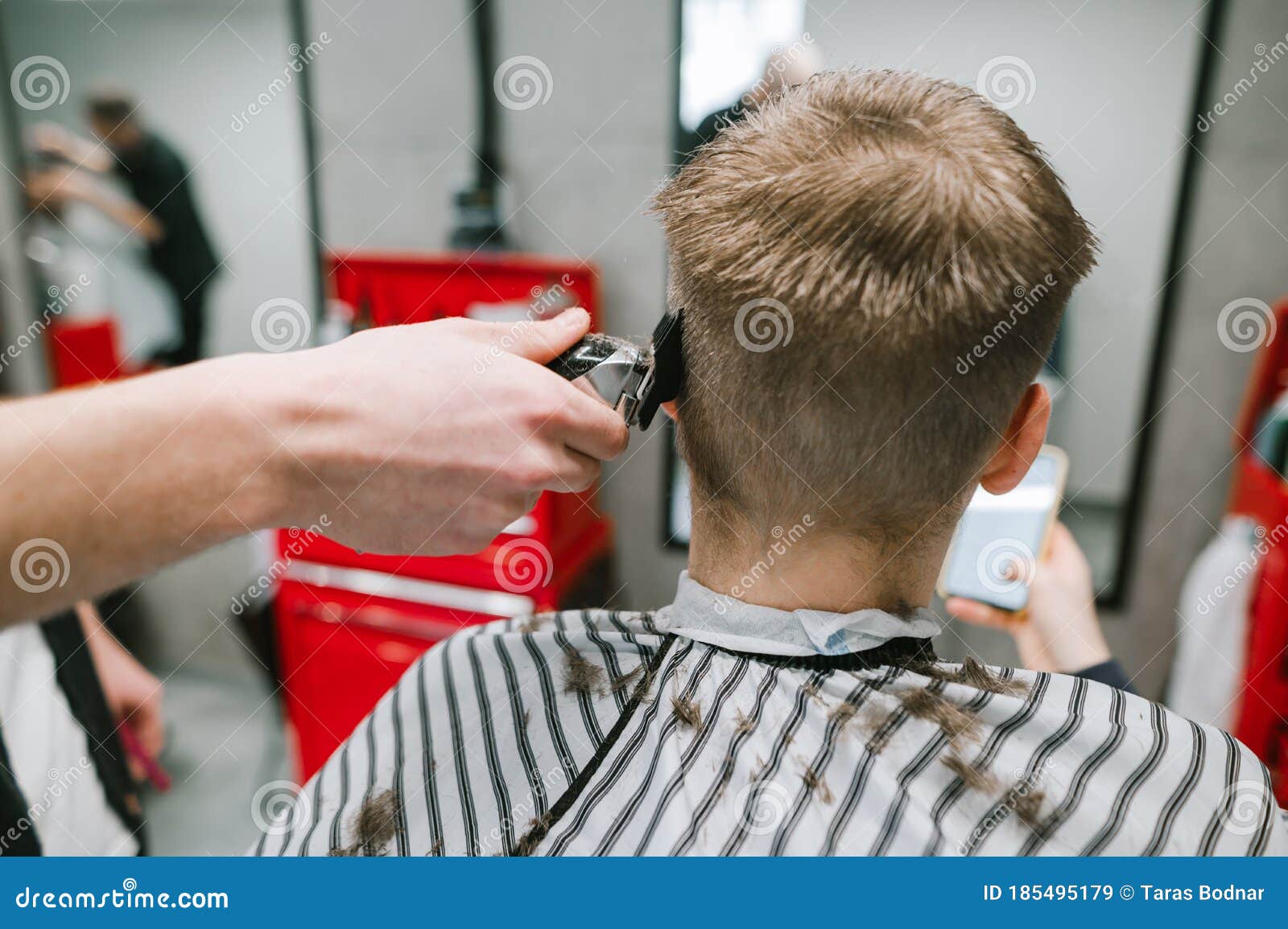 Crop unrecognizable hairdresser using scissors to cut fair hair of client  in beauty salon Stock Photo  Alamy