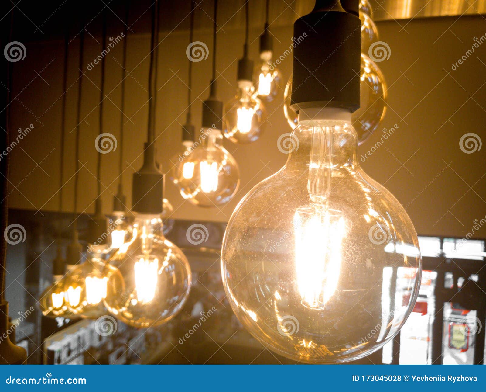 Closeup Image of Incandescent Light Bulbs Glowing Under the Ceiling