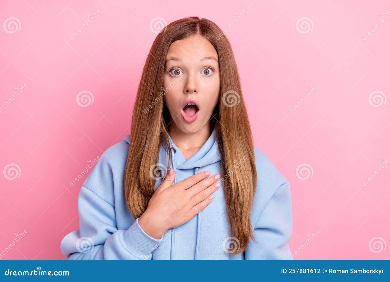 Closeup Photo Of Young Funny Excited Shocked Little Schoolgirl Wear Blue Hoodie Touch Chest 