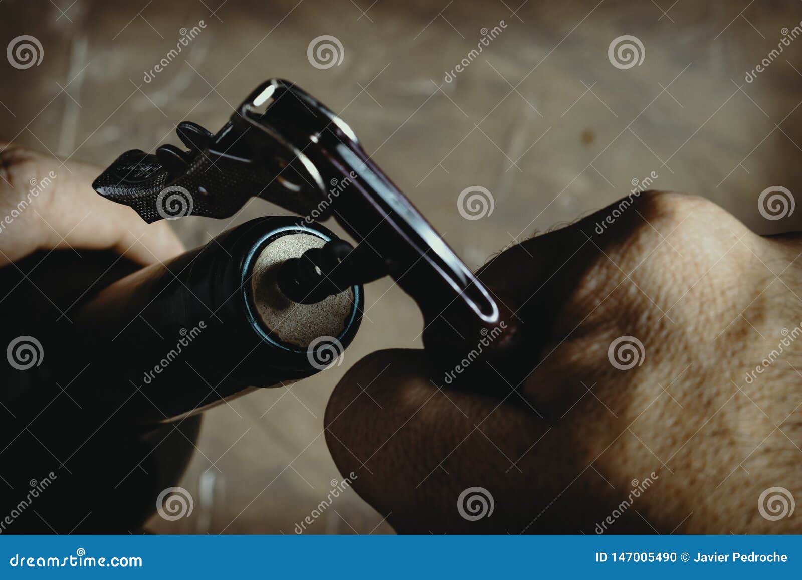 Hand Using Corkscrew To Extract Cork from a Bottle Stock Photo Image