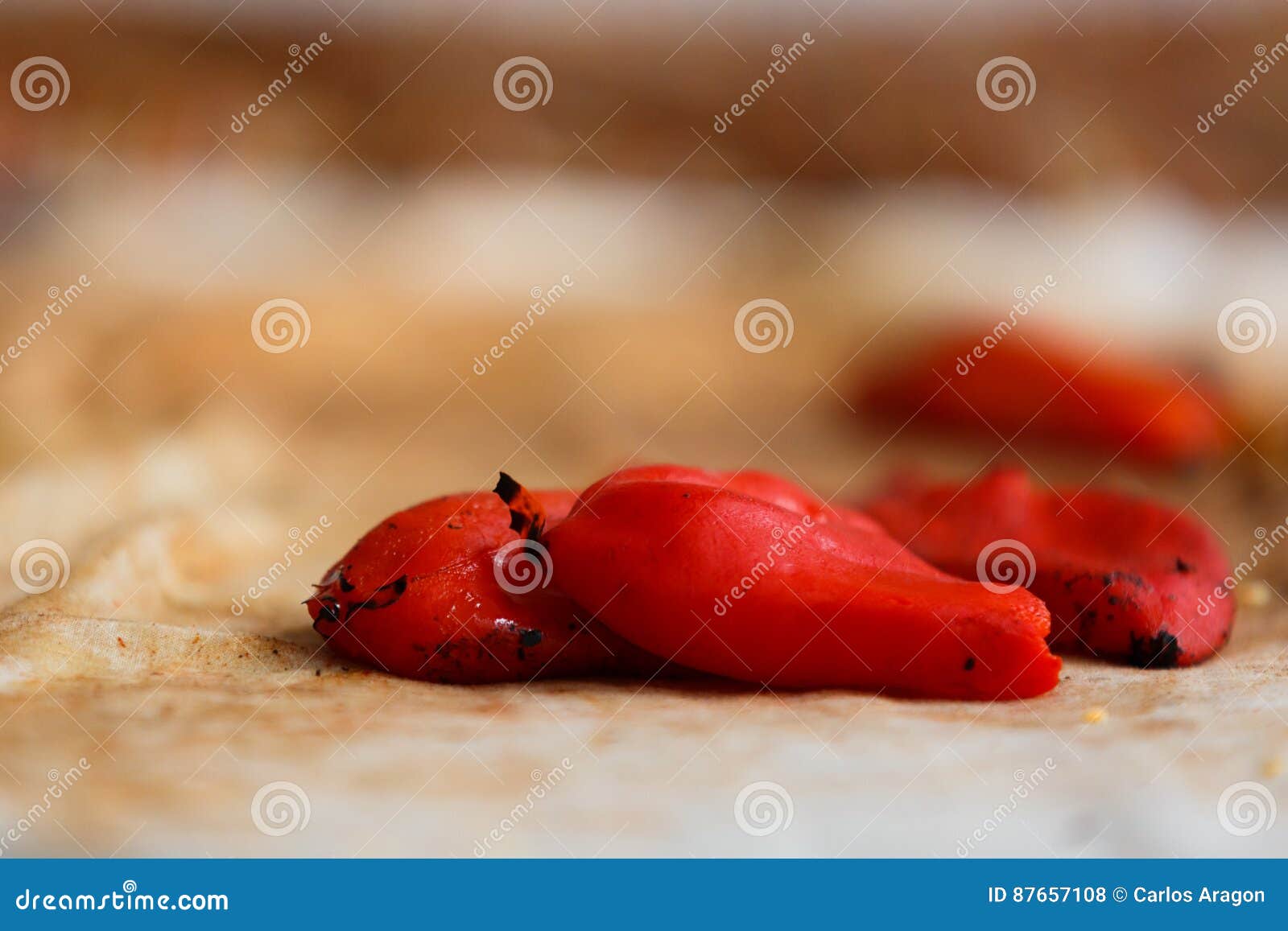 closeup of a pile of freshly baked piquillo peppers on a rag, in lodosa