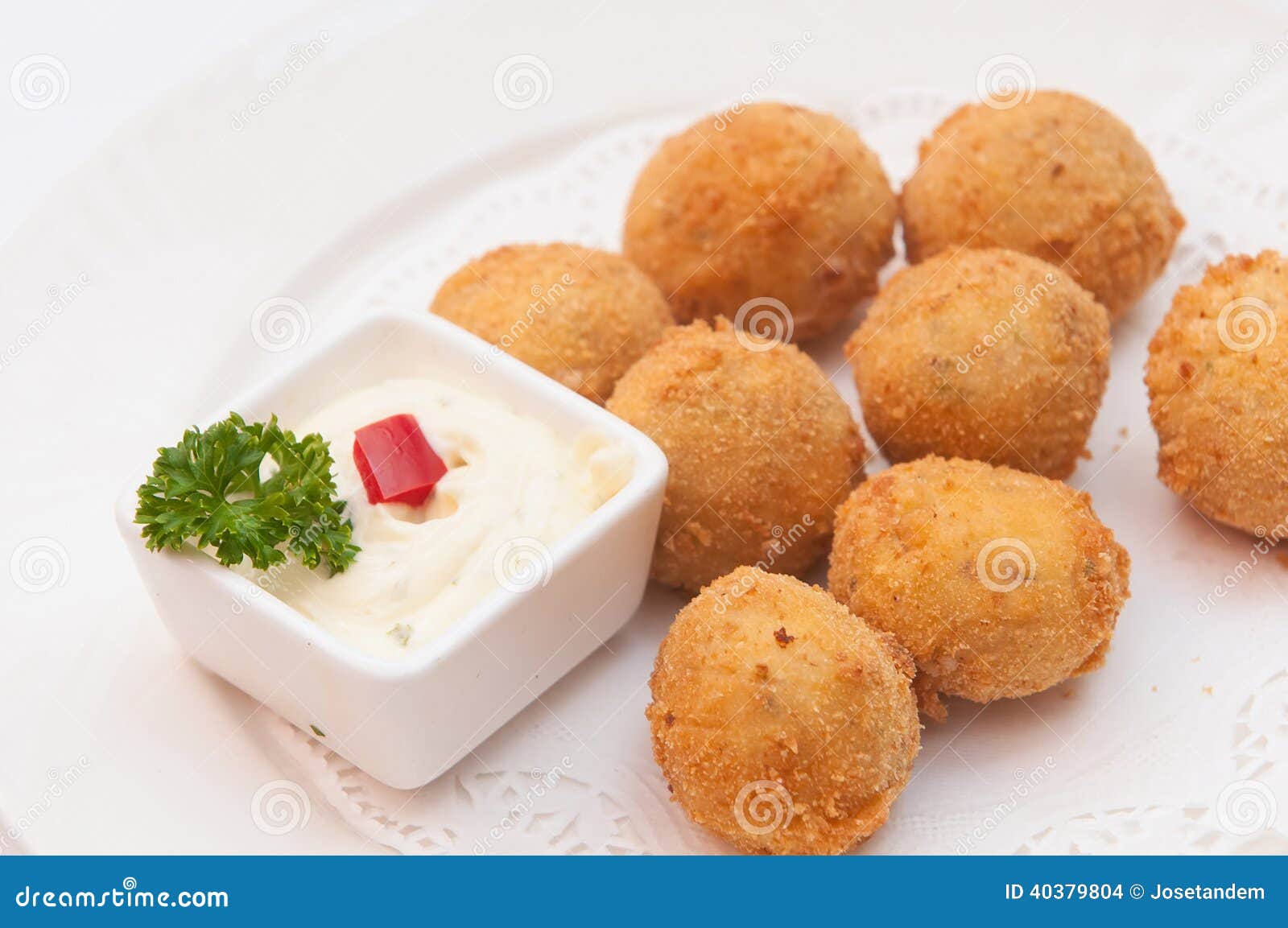 closeup of a plate with croquetas, spanish croquettes, on a set table