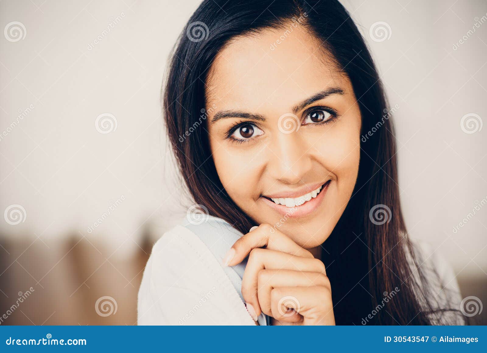 Closeup Portrait Of Attractive Indian Young Woman Smiling At Home Stock